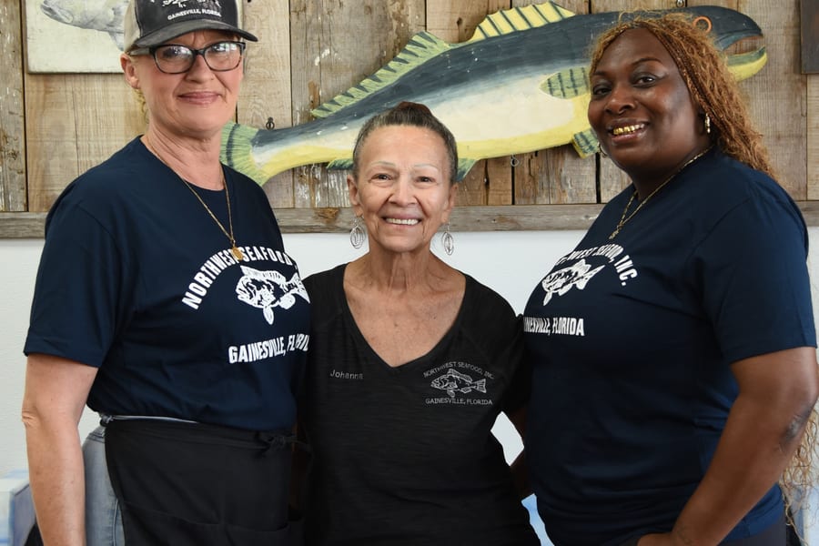 Northwest Seafood staff helping a customer at the seafood counter